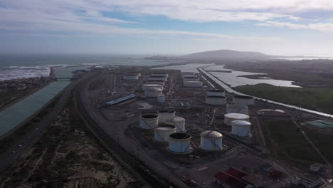 Aerial-drone-view-over-an-oil-gaz-storage-Sete-in-background.-Coastal-canal